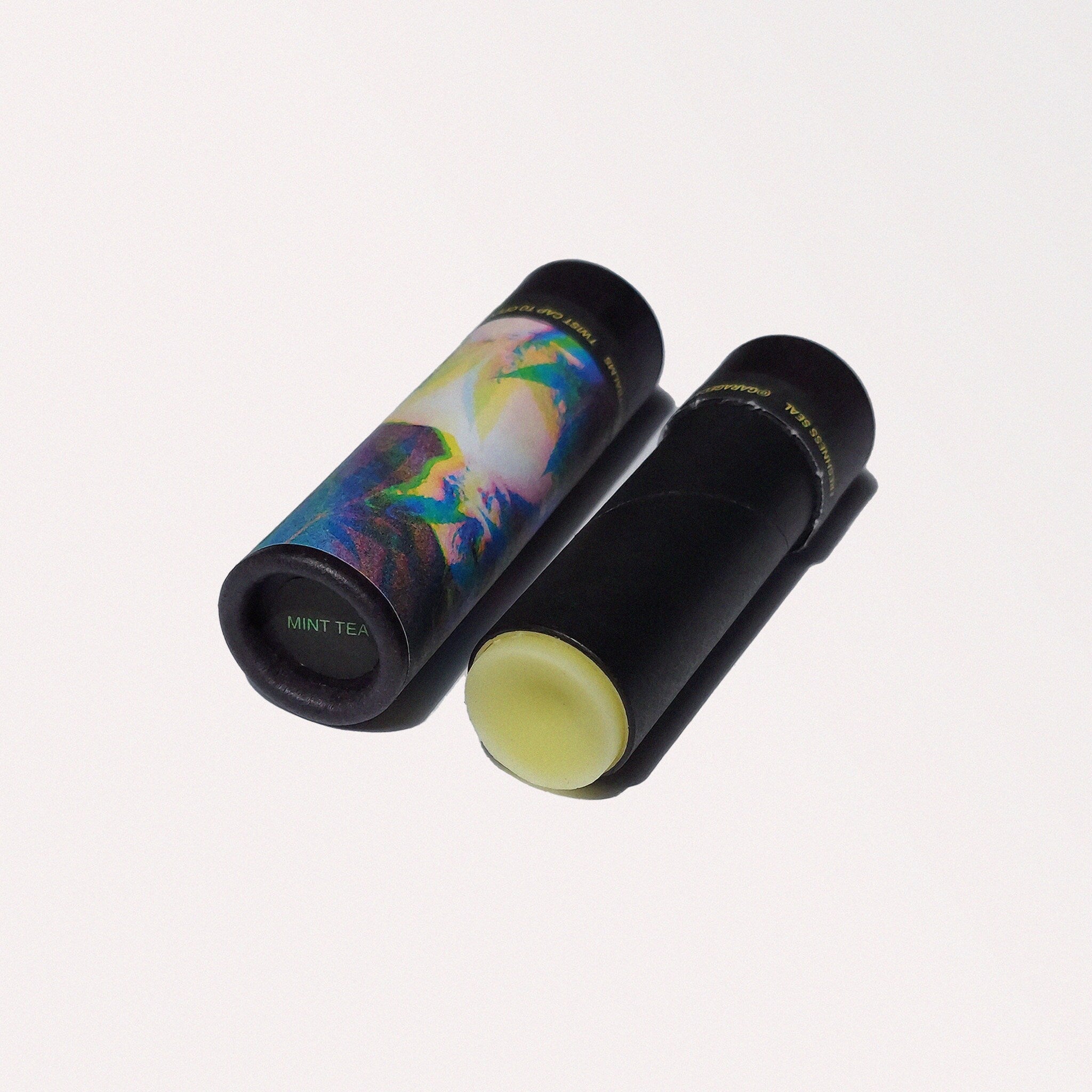 Lip balm tubes, black and patterned paper tubes, with visible lip balm, GarageCats brand