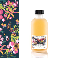 Facial toner bottle with yellow liquid, black cap, and Leaf Seed Berry label