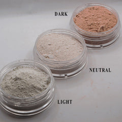 Powder makeup in light, neutral, and dark shades, in clear plastic jars