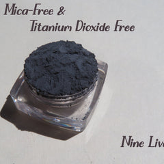 Dark gray matte loose mineral eyeshadow in a round black jar with silver lid, vegan and cruelty-free makeup pigment