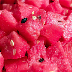 Watermelon slices, bright red with black seeds and white seeds, close-up view