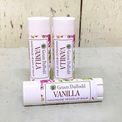 Vanilla lip balm tubes, white with floral pattern and Green Daffodil text, for moisturizing lips