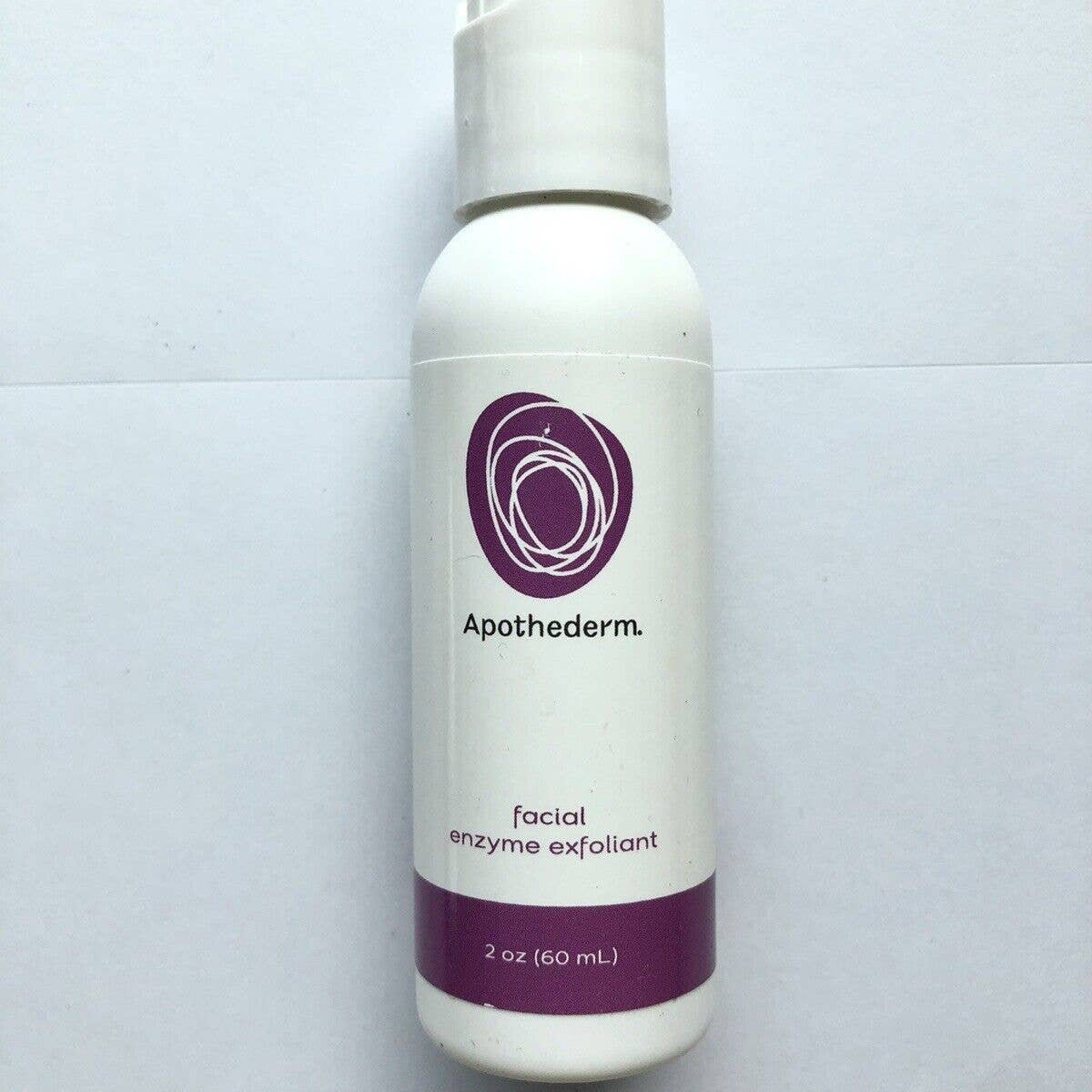 Facial enzyme exfoliant bottle with white and purple label, Apothederm brand, for skincare