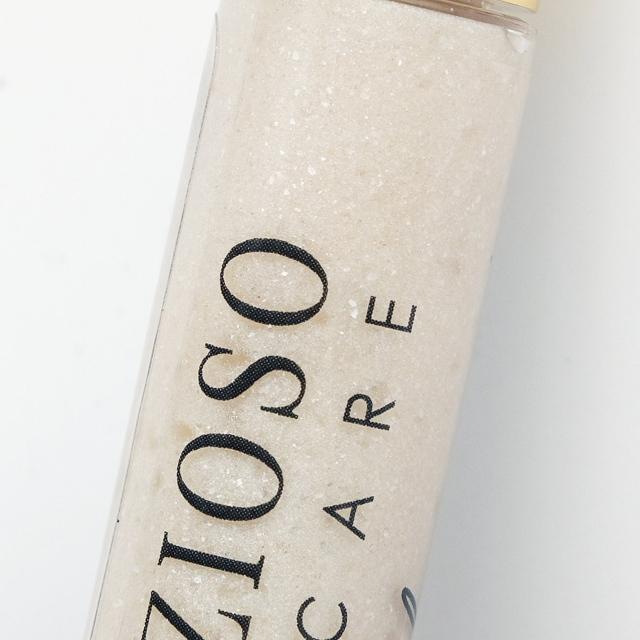 Bath salts in clear bottle with beige granules and black ZIO CARE text