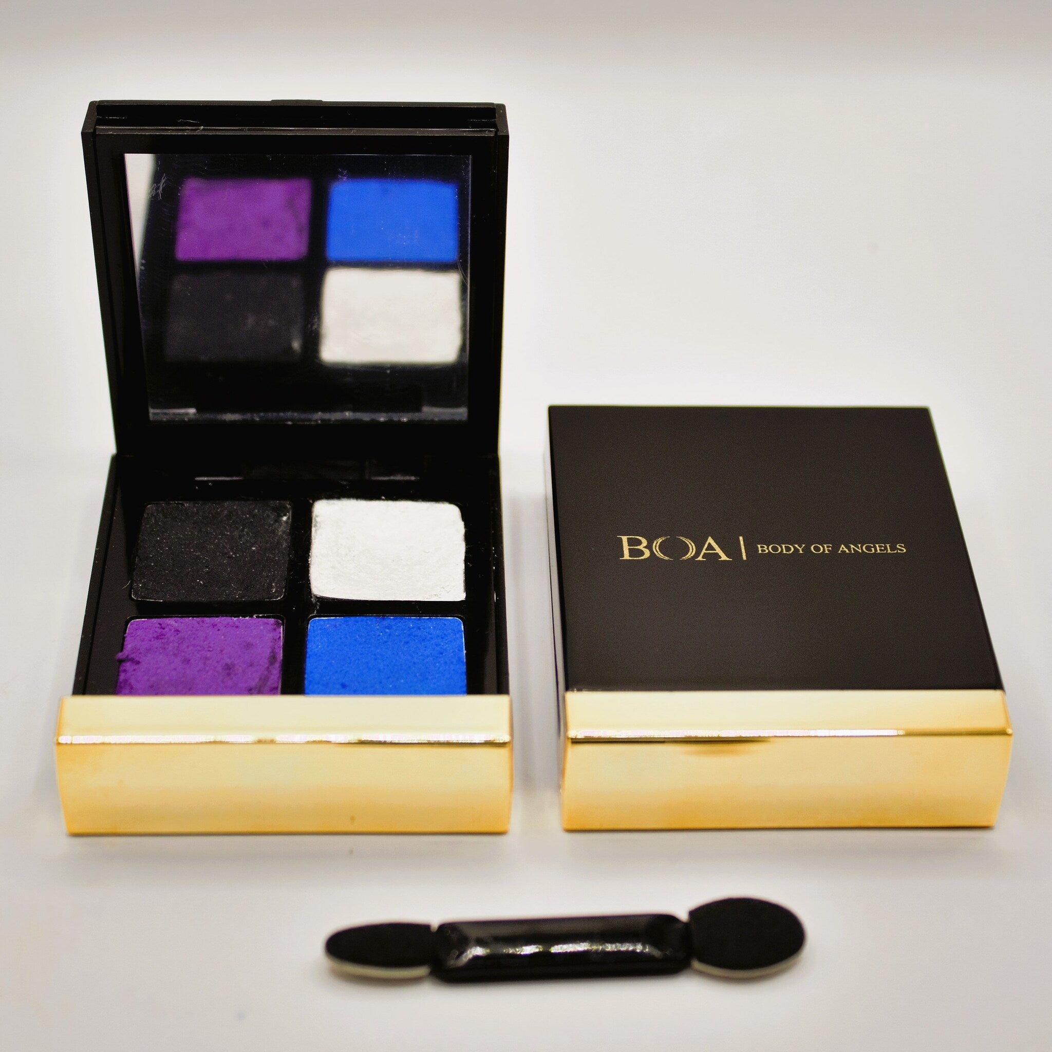 Eyeshadow palette with black, gold, and colorful eyeshadows, BOAI brand name visible