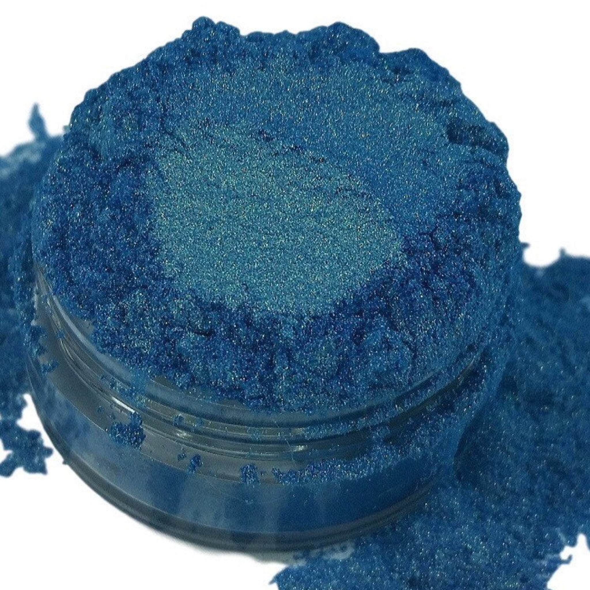Metallic blue gold eyeshadow pot with iridescent mermaid shimmer and smooth mineral texture