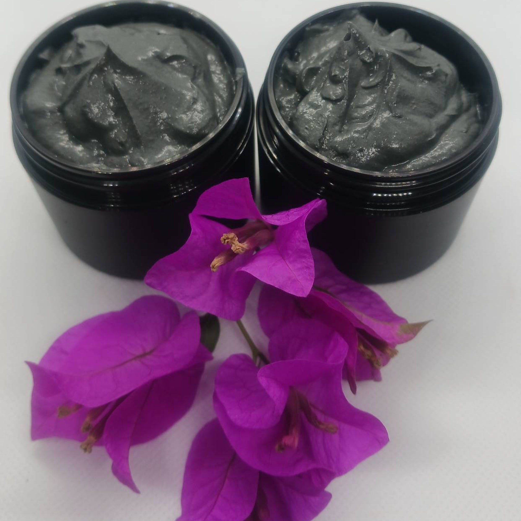 Black and gold jar of activated charcoal turmeric face mask with matte finish and minimalist branding