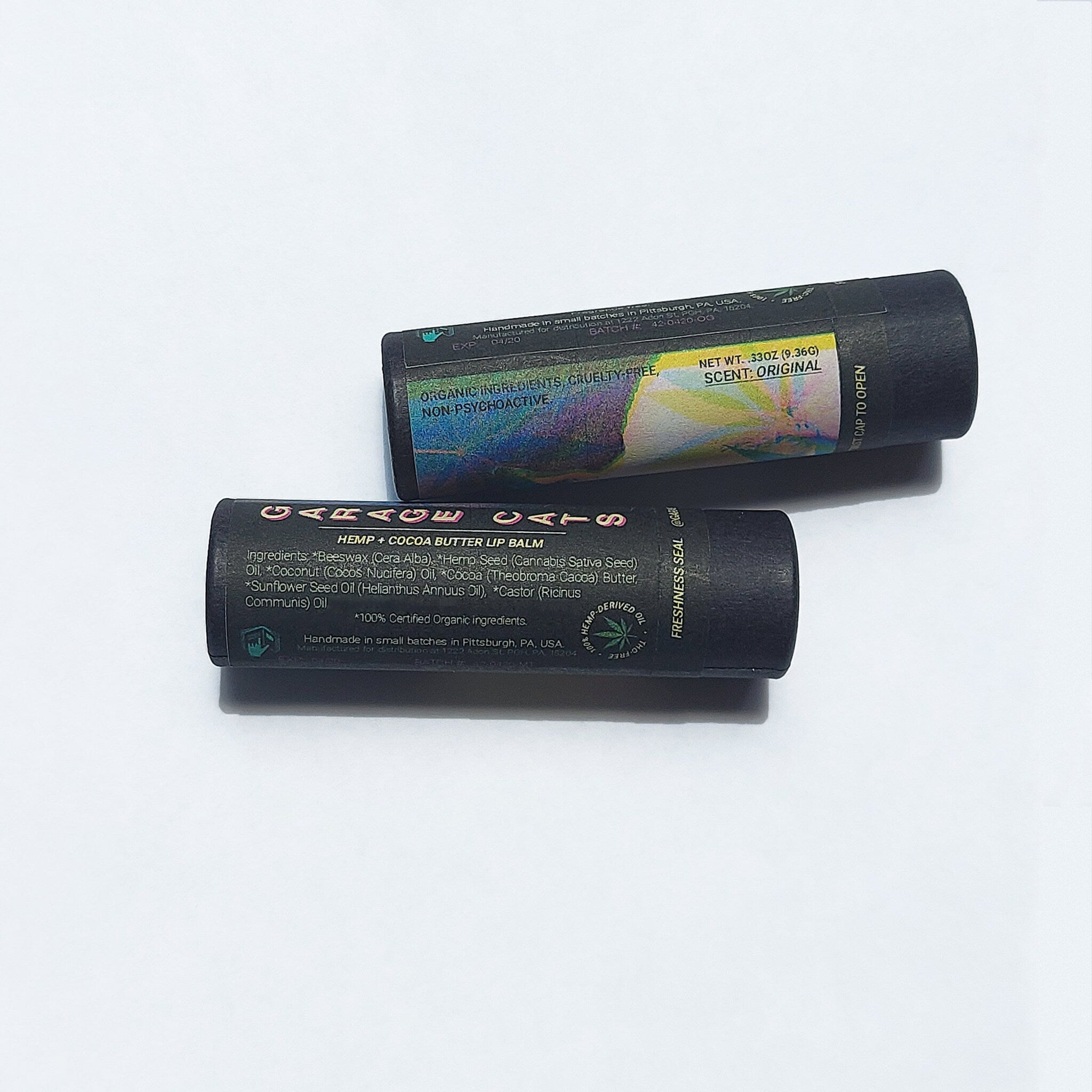 Lip balm tubes in black with Garage Cats label, white background, original scent.