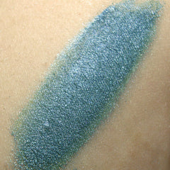 Close-up of Ligeia mineral eye shadow showing finely milled powder texture in a shimmering bronze shade