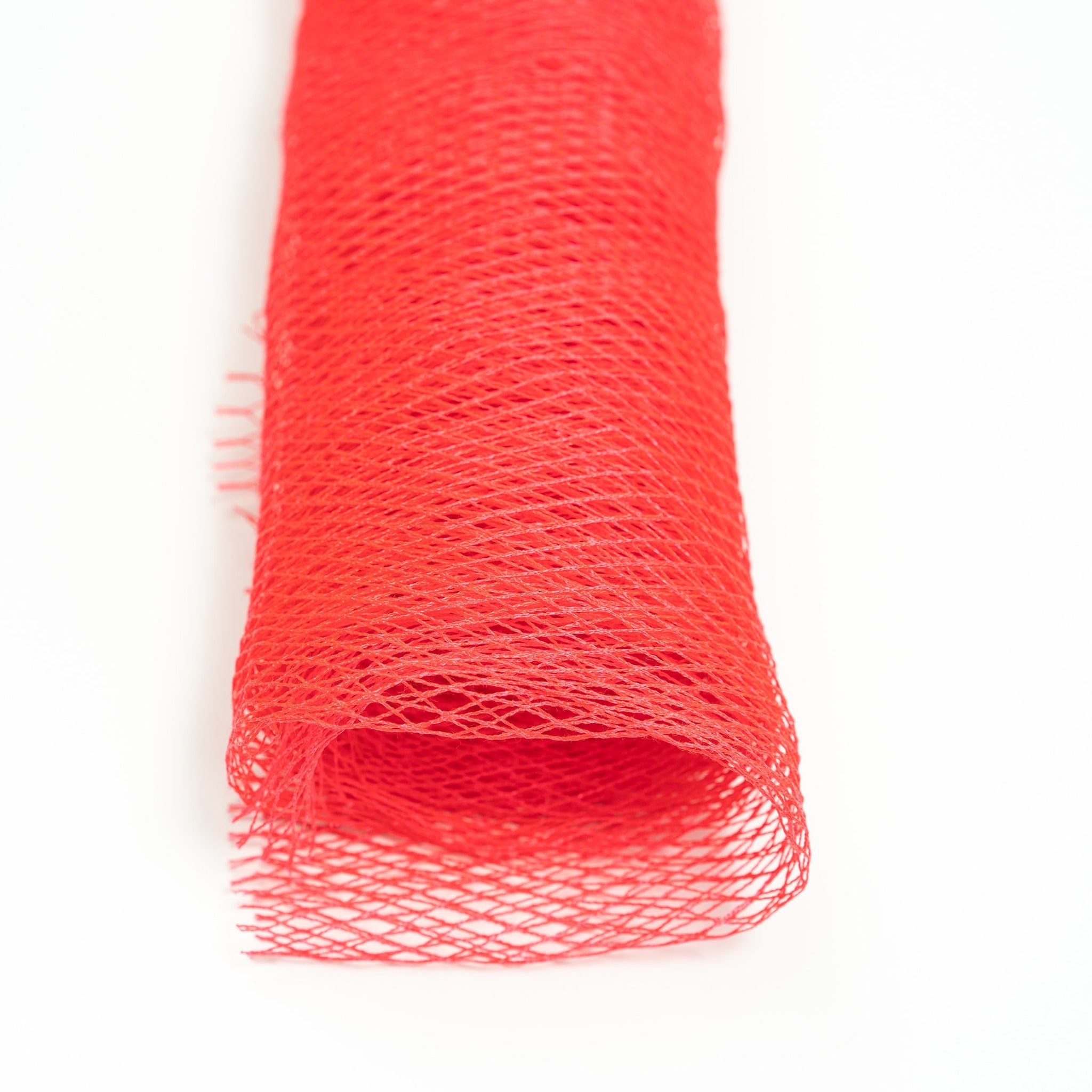 Red mesh netting with diamond pattern on white background