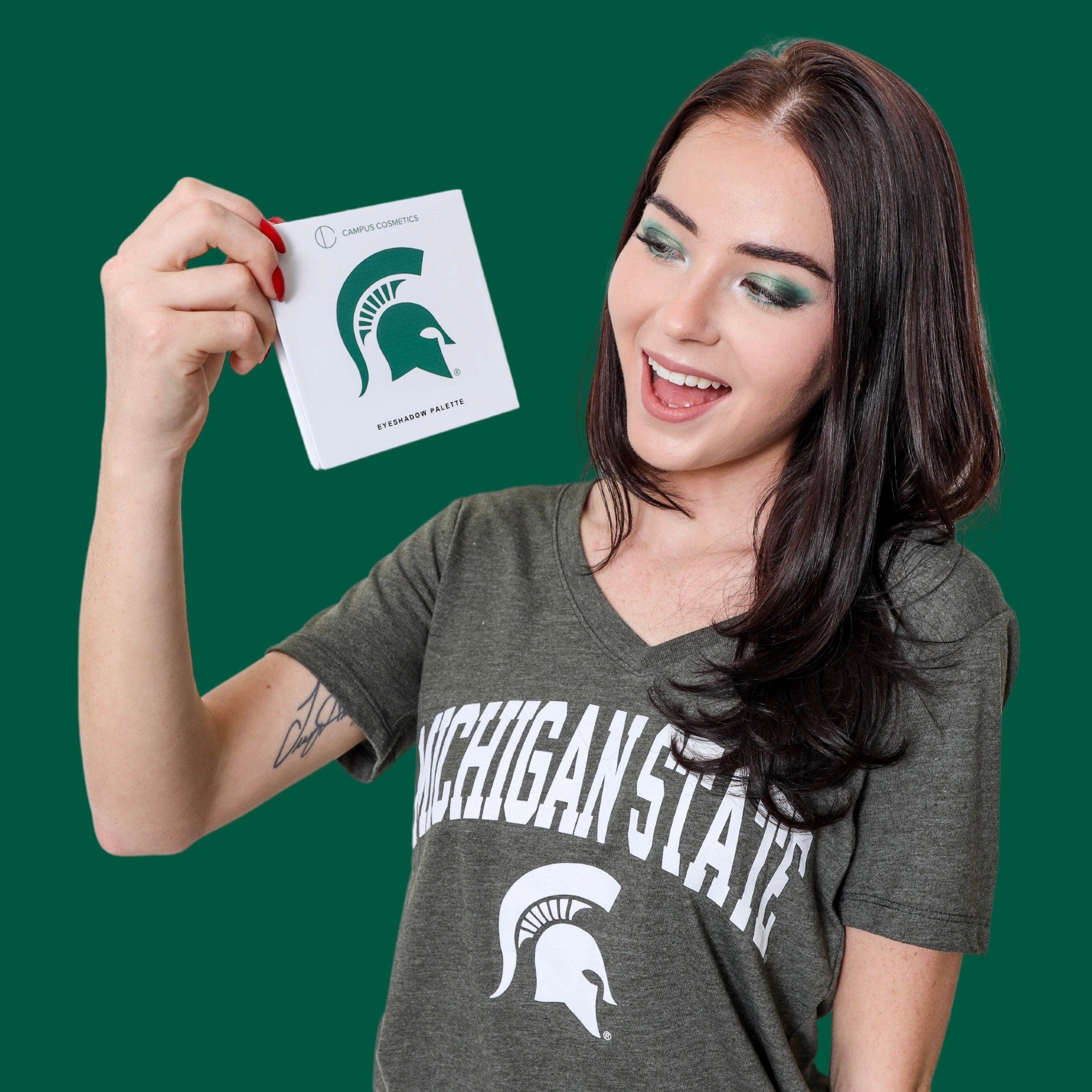 Side view of Michigan State University green and white eye shadow palette with matte and shimmer finishes