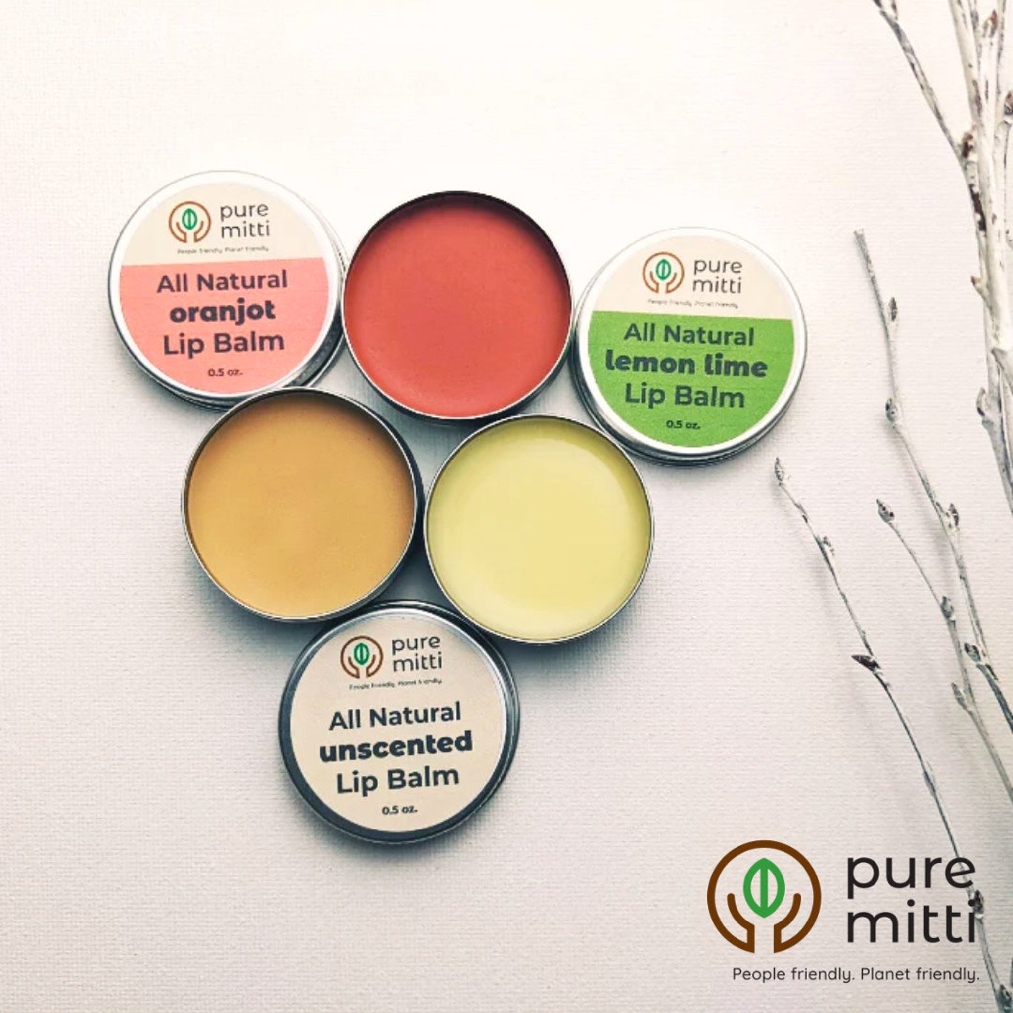 Lip balm tins with various colors, metal containers, and brand name pure mitti visible