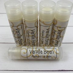 Lip balm tubes with clear, white, and gold label, product name visible