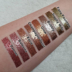 Close-up of pressed glitter eyeshadow with vibrant multicolor sparkles in a compact palette