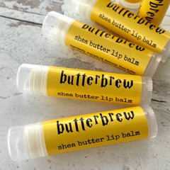 Shea butter lip balm in yellow tube with "butterbrew" text, clear cap