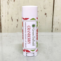 Lip balm tube, white and red patterned, with Green Daffodil branding and cranberry text