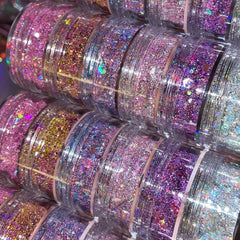 Close-up of iridescent chunky glitter eye shadow in a stack set, showing vibrant multicolor sparkle texture
