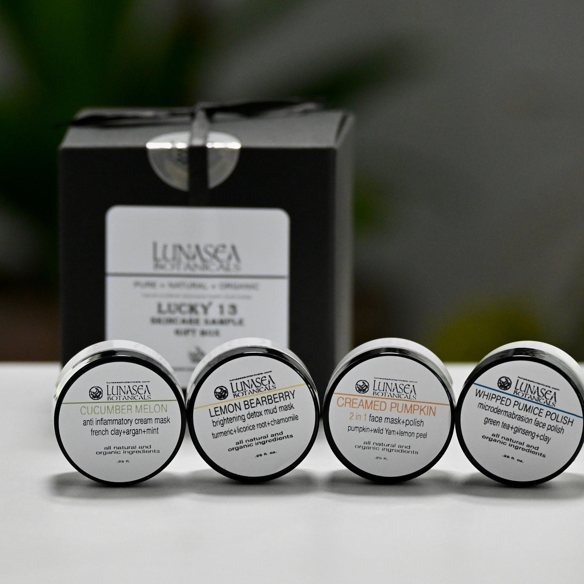 Face mask jars with black lids, white labels, and LunaSea Botanicals branding, in a gift set box