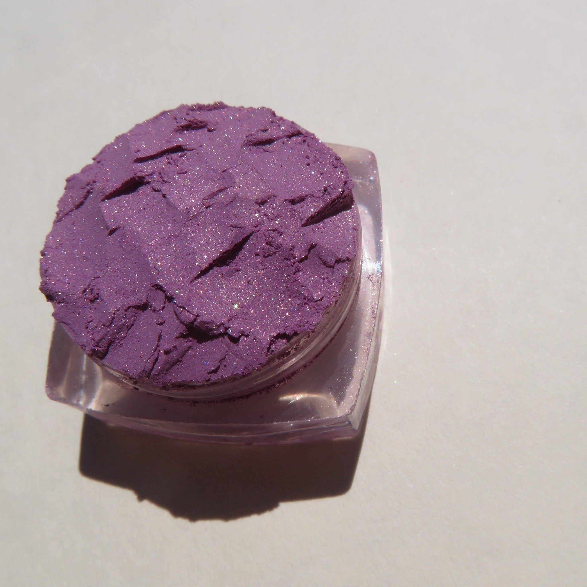 Close-up of Jessica Pure Mineral Eyeshadow in purple shimmer loose pigment with sparkling flecks