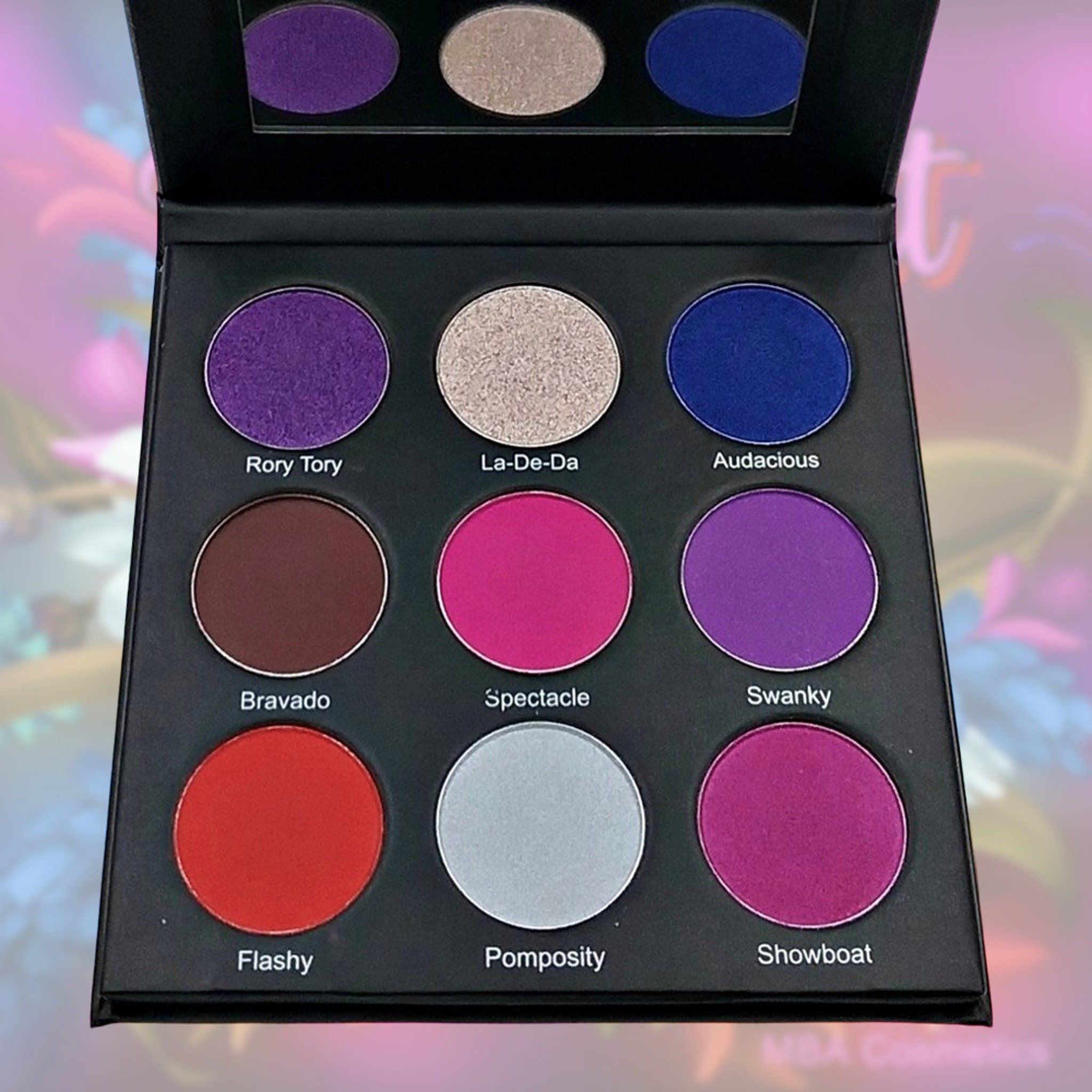 Flamboyant Eyeshadow Palette open to reveal 12 vibrant matte and shimmer shades in a sleek black compact