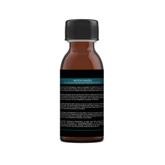 Close-up of amber glass witch hazel toner bottle with herbal extract label and spray nozzle