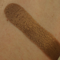 Close-up of amber brown shimmer pressed pigment in 26mm pan with metallic sheen