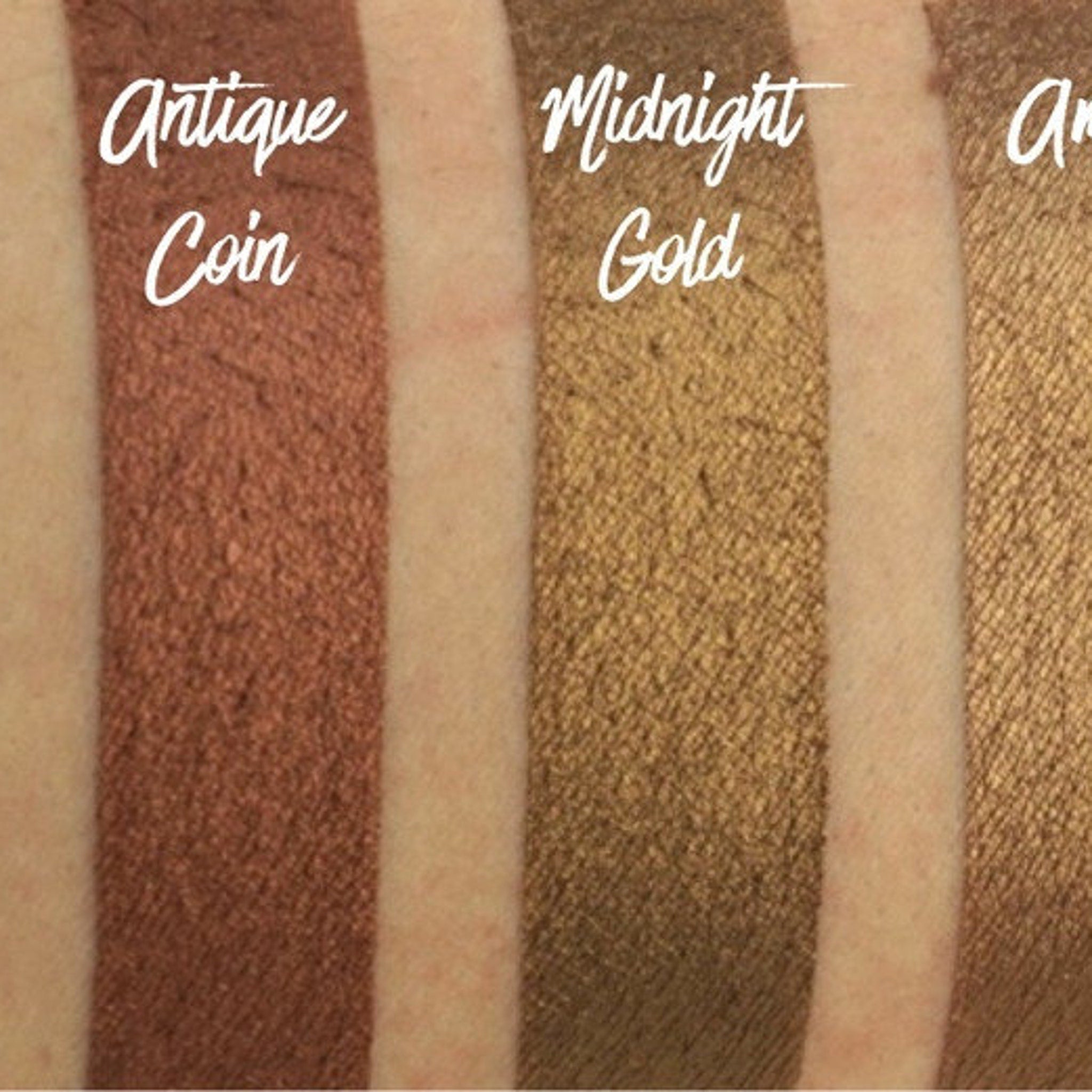 Hand applying amber brown shimmer eyeshadow with a brush, showcasing rich pigment and metallic finish