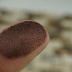 Close-up of pressed vegan chocolate brown shimmer eye shadow in 26mm pan with metallic finish