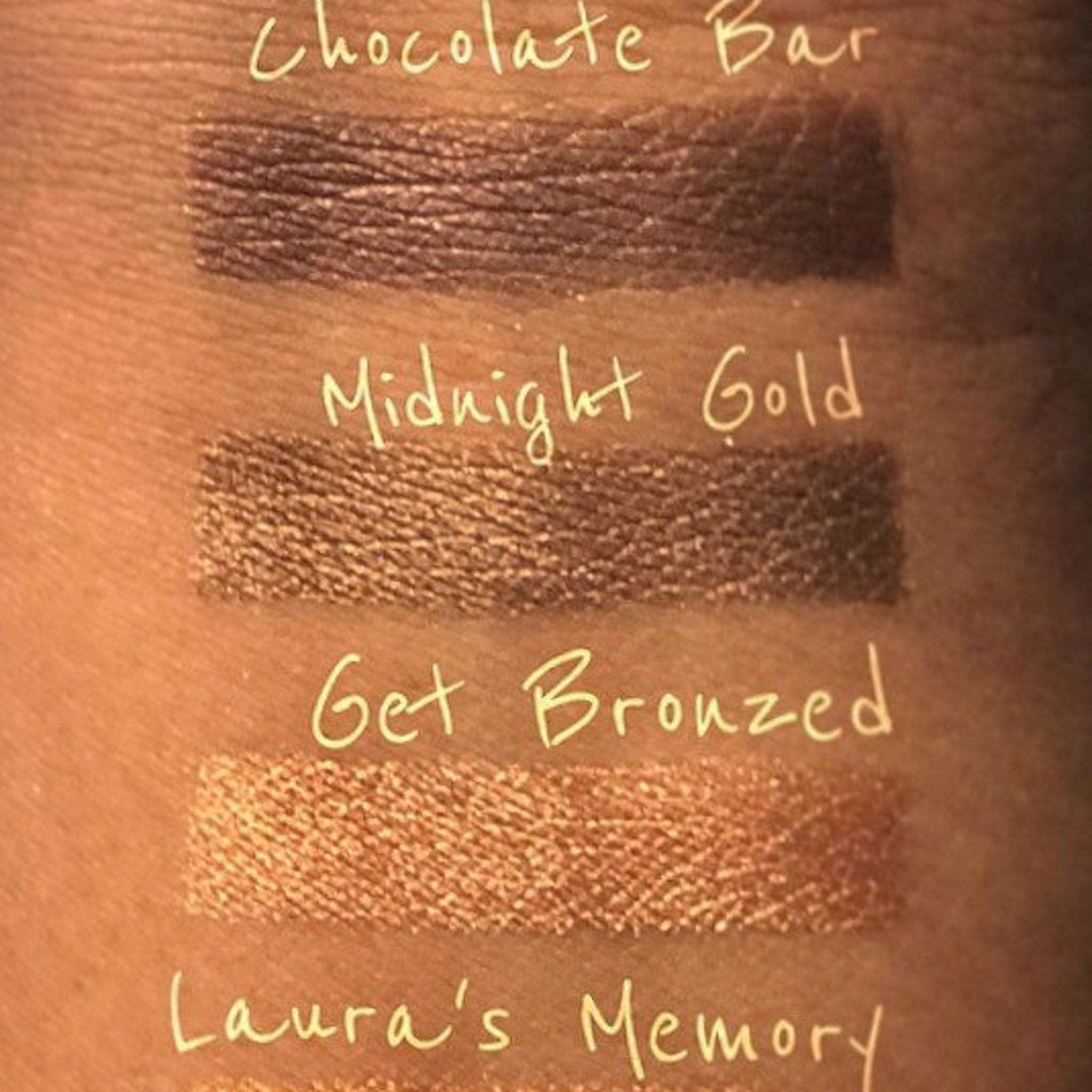 Close-up of pressed vegan chocolate brown shimmer eye shadow pan with metallic finish