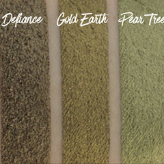 Hand applying pearlescent green shimmer eyeshadow with fingertip onto eyelid, showcasing vibrant pigment payoff
