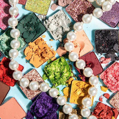 Side view of Pearl Paradise eyeshadow palette displaying 32 shimmer and matte shades in warm neutrals and jewel tones
