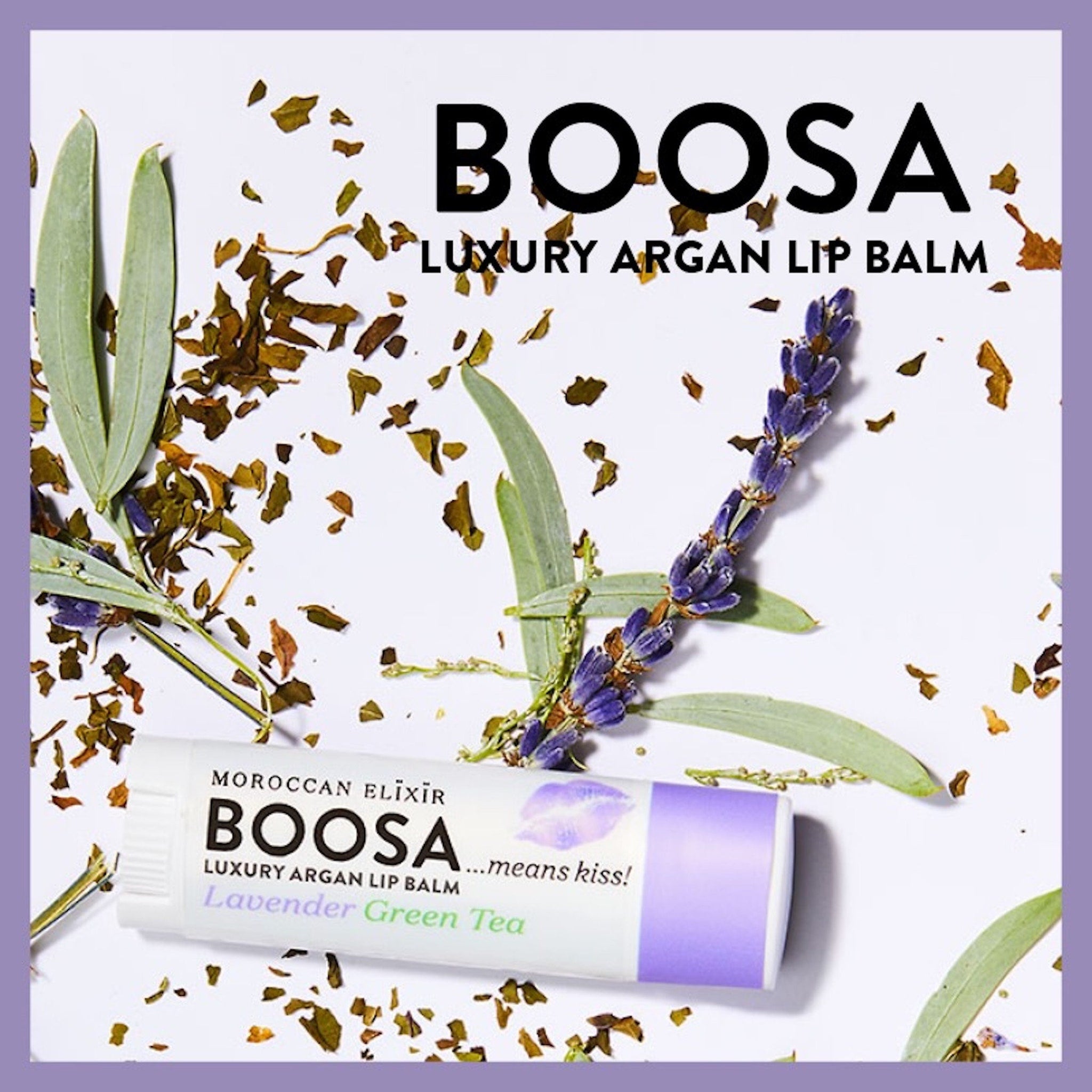 Lip balm tube with white and purple packaging, lavender sprig, and green leaves on white background