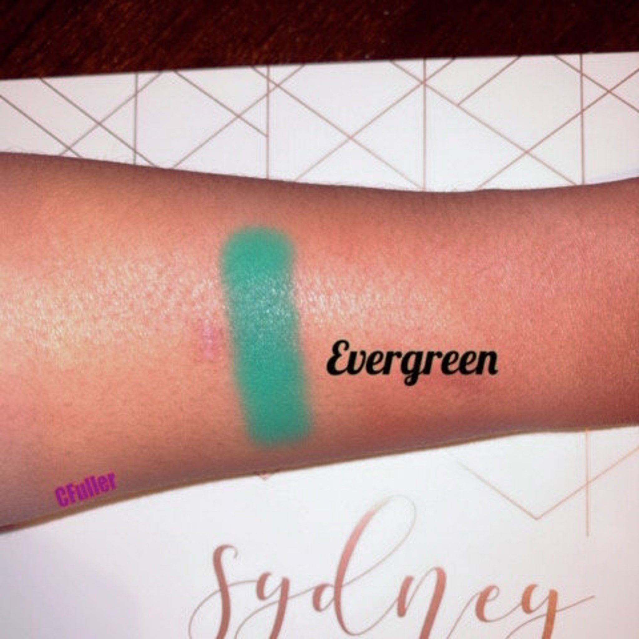 Side view of evergreen matte eyeshadow pan showing pressed powder texture and 26mm circular compact