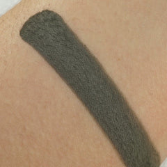 Close-up of matte moss green eyeshadow pan showing smooth pressed powder texture and true-to-color pigment