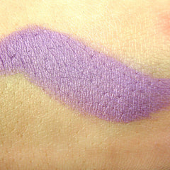 Close-up of Bittie Mineral Pigment Eye Shadow showing finely milled powder texture in vibrant shimmering shade