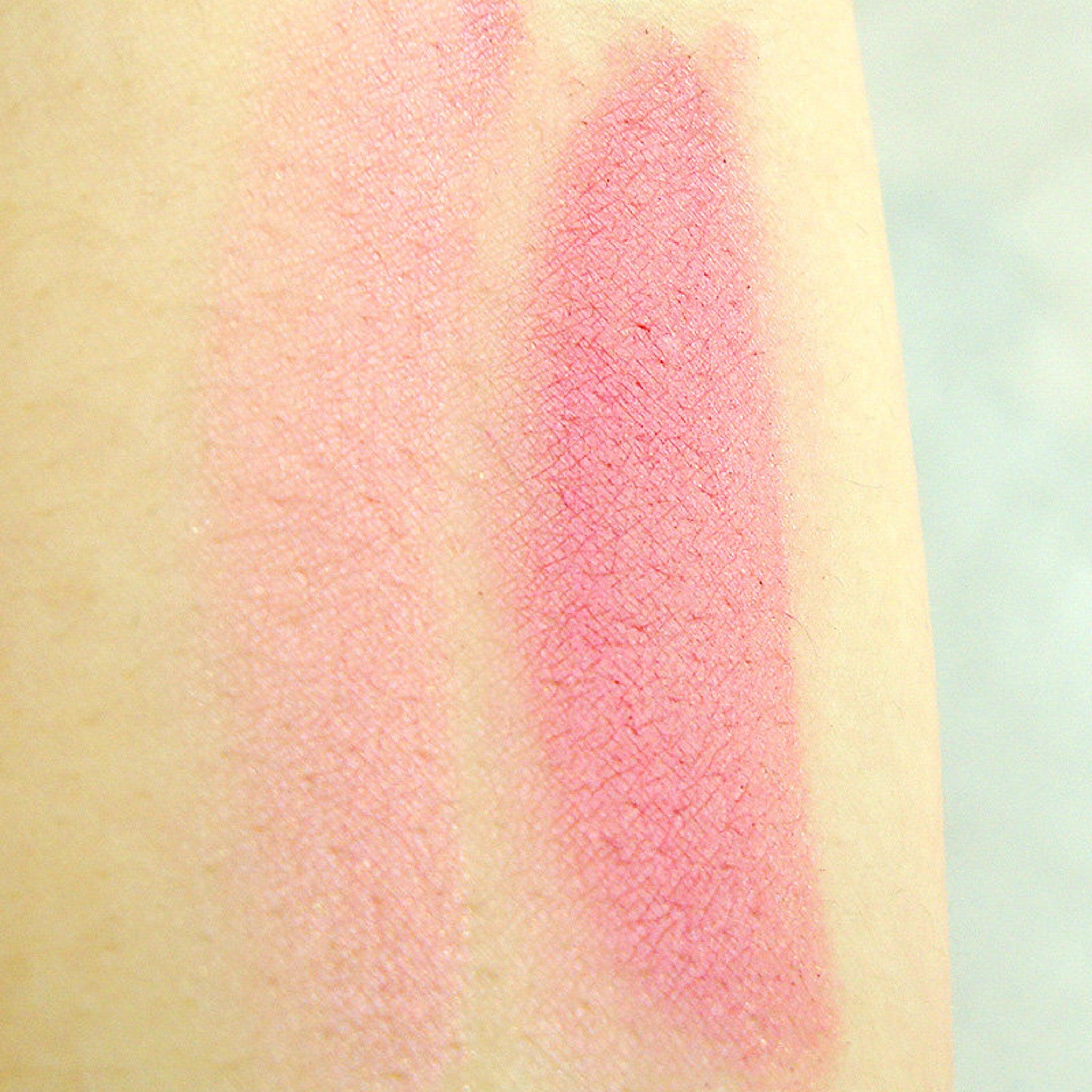 Close-up of shimmering Candy Darling mineral eye shadow with pink and gold flecks in compact case