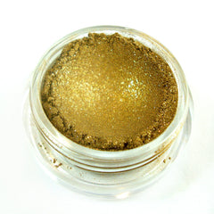 Close-up of mineral eye shadow pan showing finely milled shimmering taupe powder with smooth texture