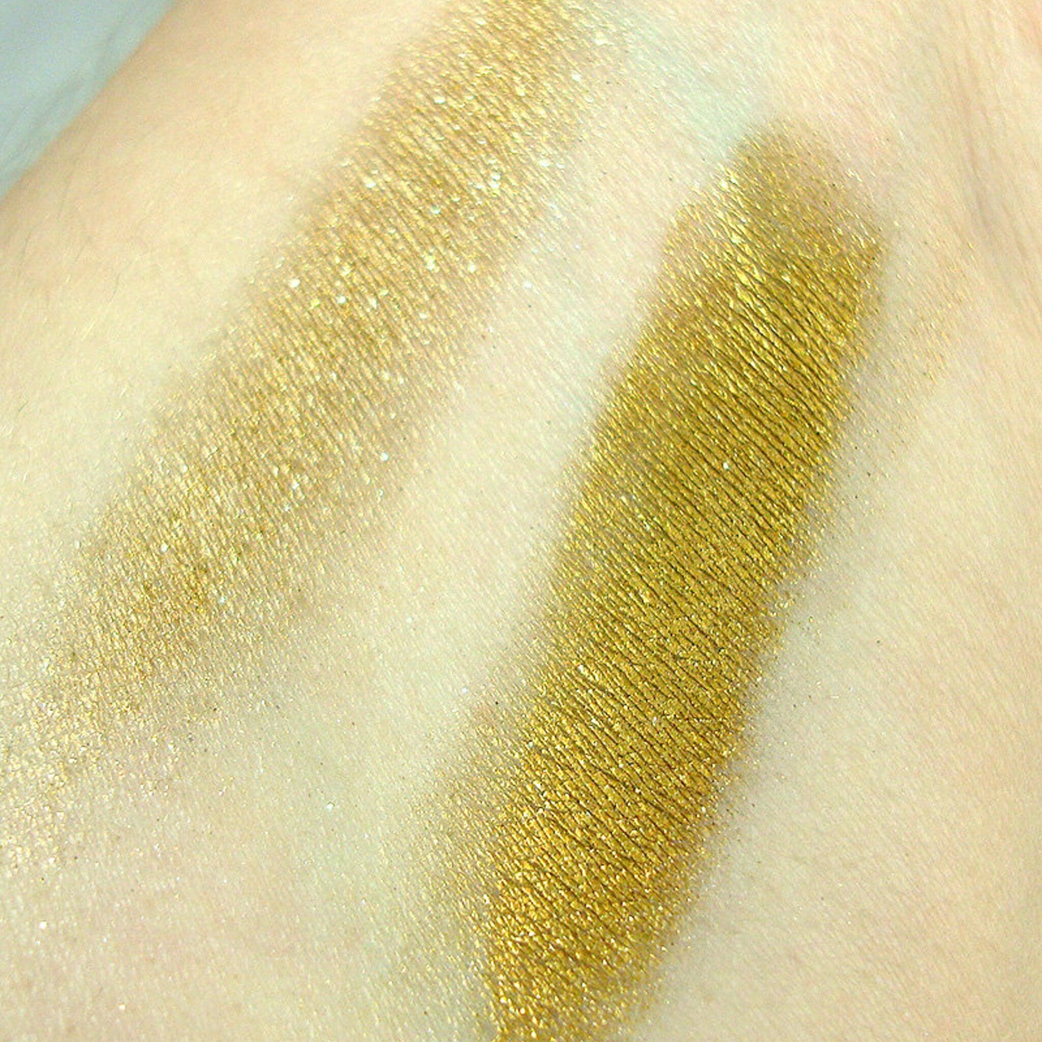 Side view of Mineral Pigment Eye Shadow pot showing pressed powder texture in shimmering bronze hue