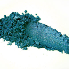 Close-up of Ligeia mineral eye shadow pot showing finely milled powder in a shimmering bronze shade