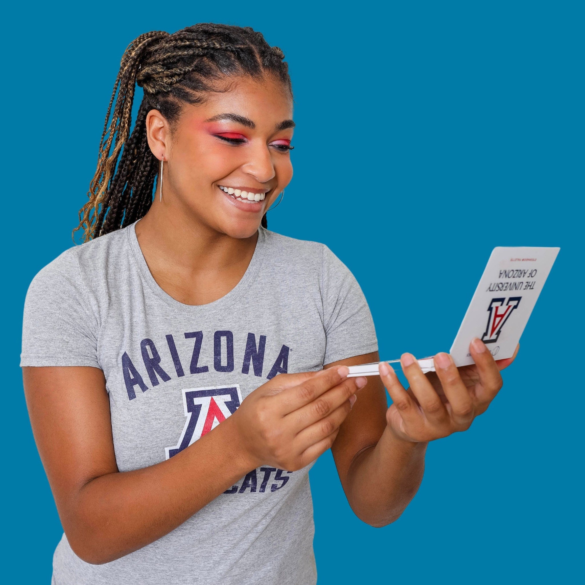 Close-up swatch of Arizona University Eye Shadow showing rich pigment and smooth matte finish on fingertip