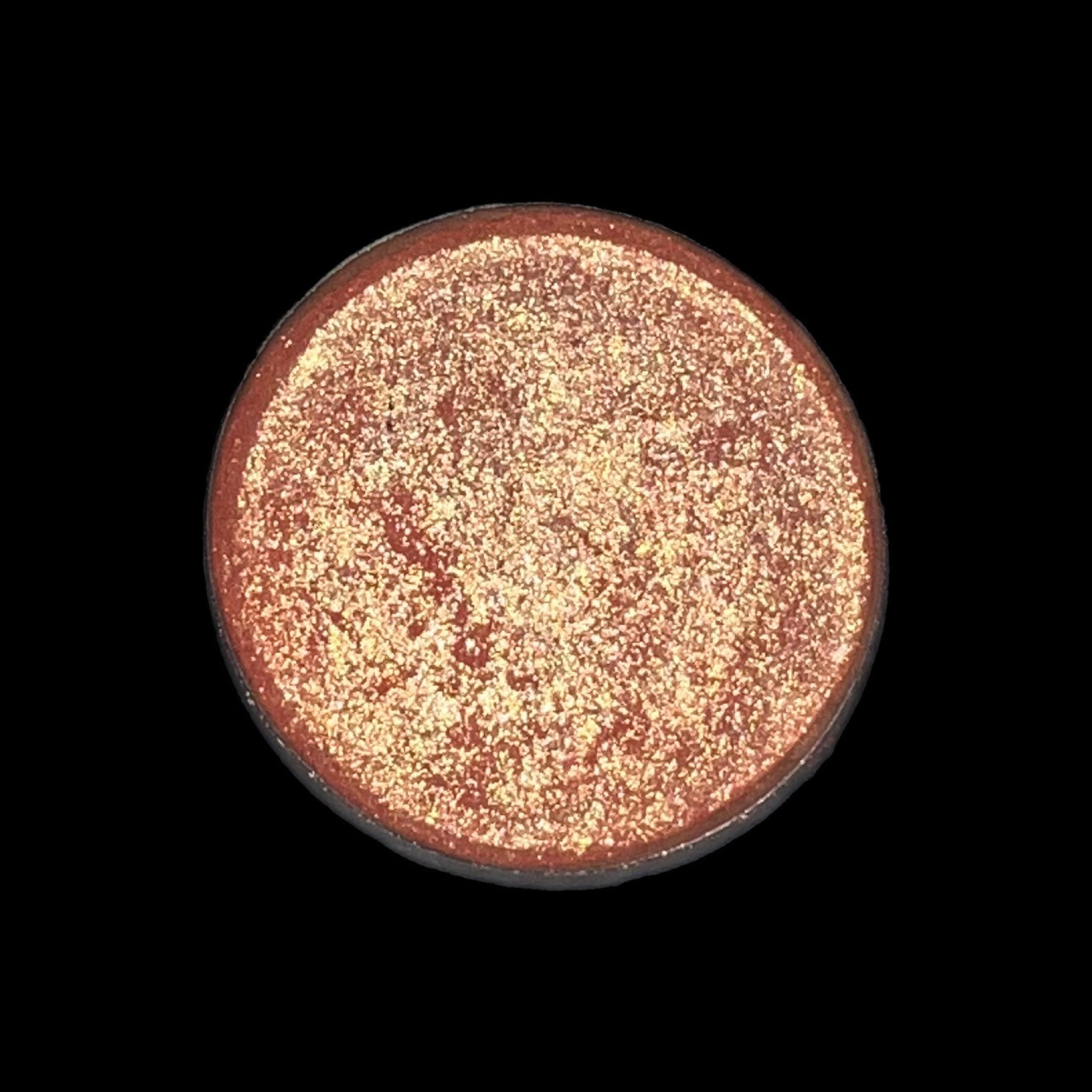 Side view of peachy pink talc-free vegan eye shadow compact showing smooth matte texture and minimalist packaging