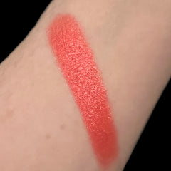 Hand applying MAC Fruit Moon eyeshadow with fingertip, showing soft peach pigment blend on eyelid