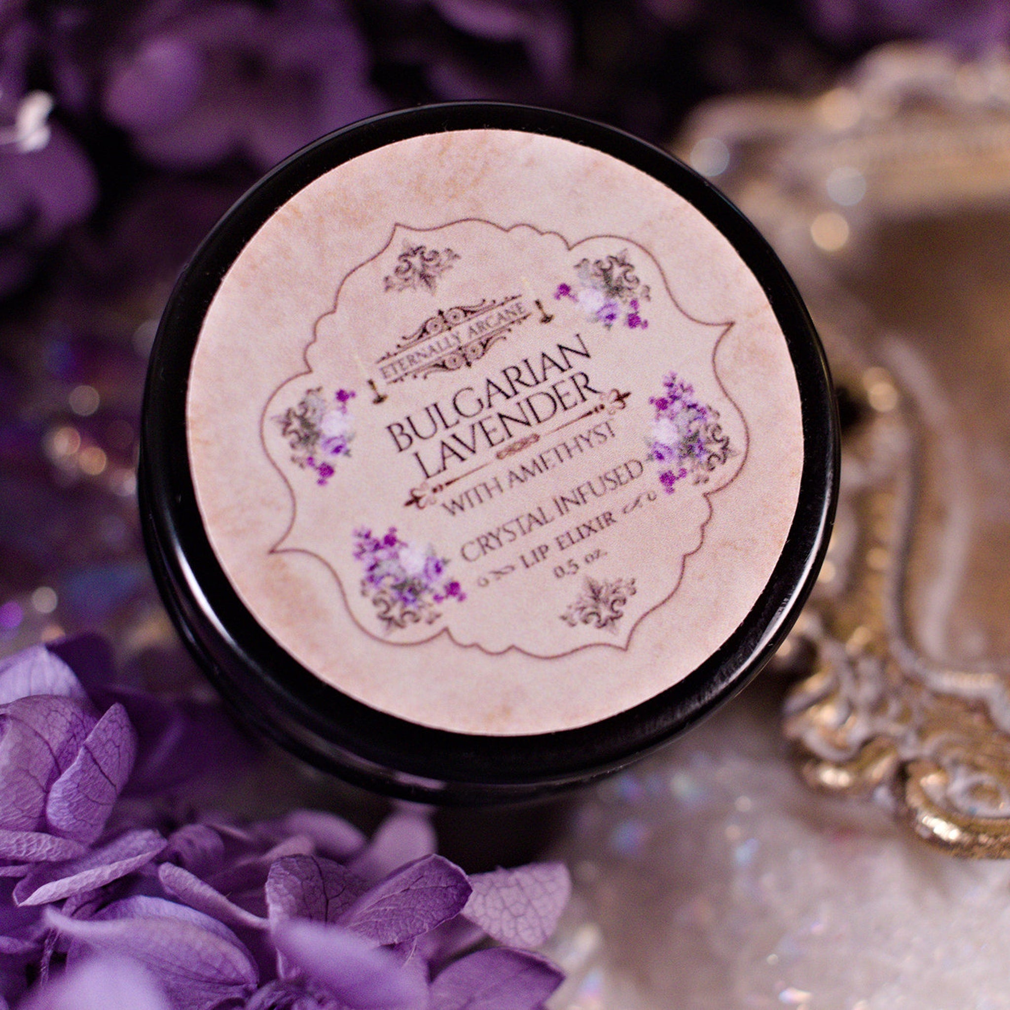 Lip Elixir with black jar, tan label, and floral design with "Bulgarian Lavender" text