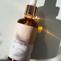 Face oil cleanser bottle, amber glass, rose gold cap, OYU label visible