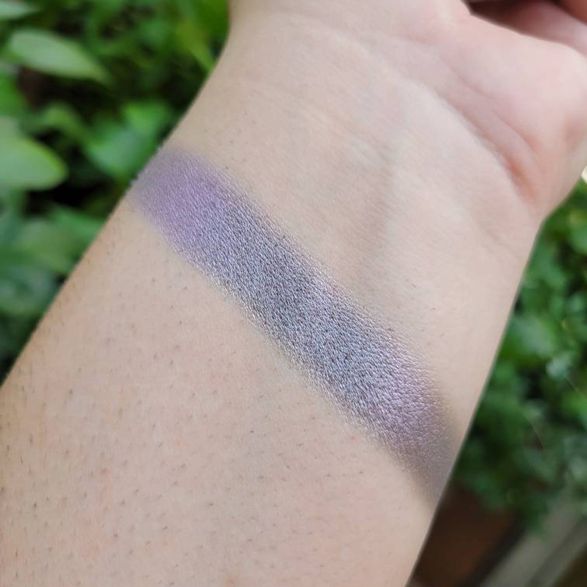 Eyeshadow swatch, lavender and silver shimmer, applied on wrist for color test