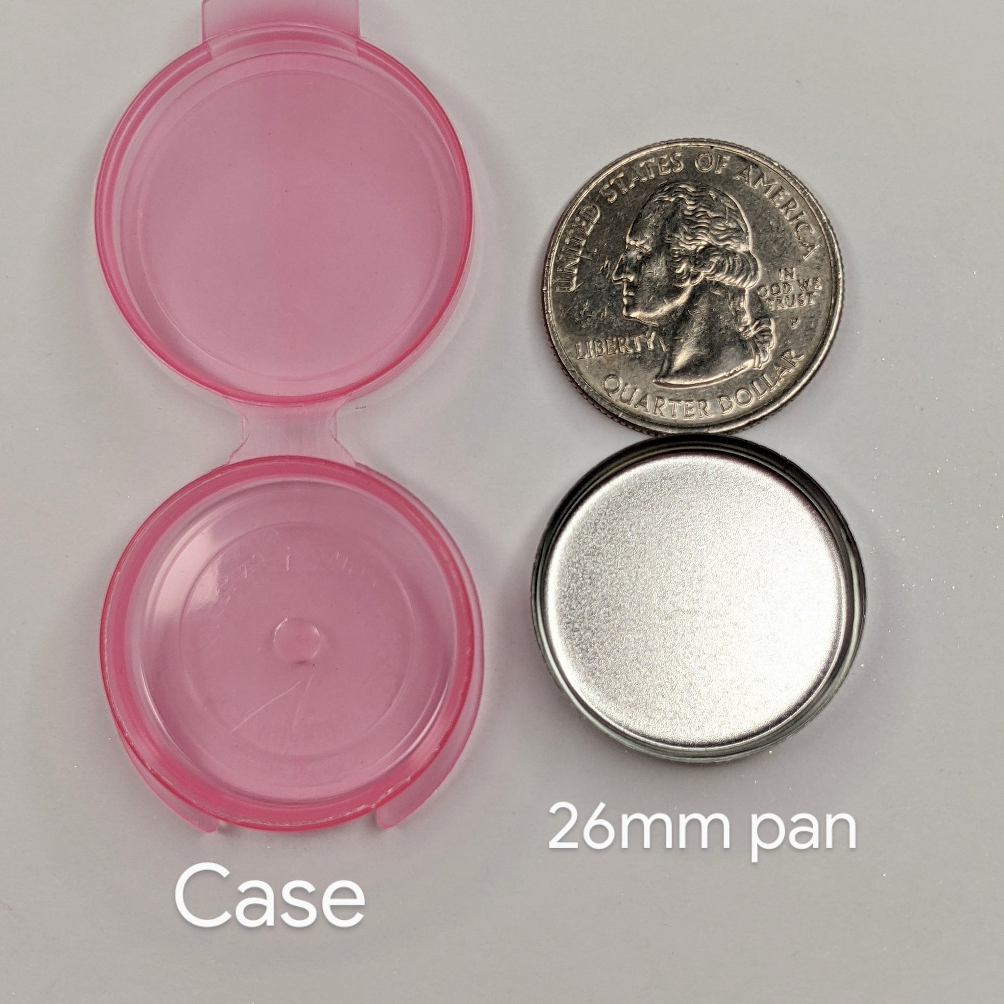 Pink plastic case with silver metal pan and quarter coin for size comparison