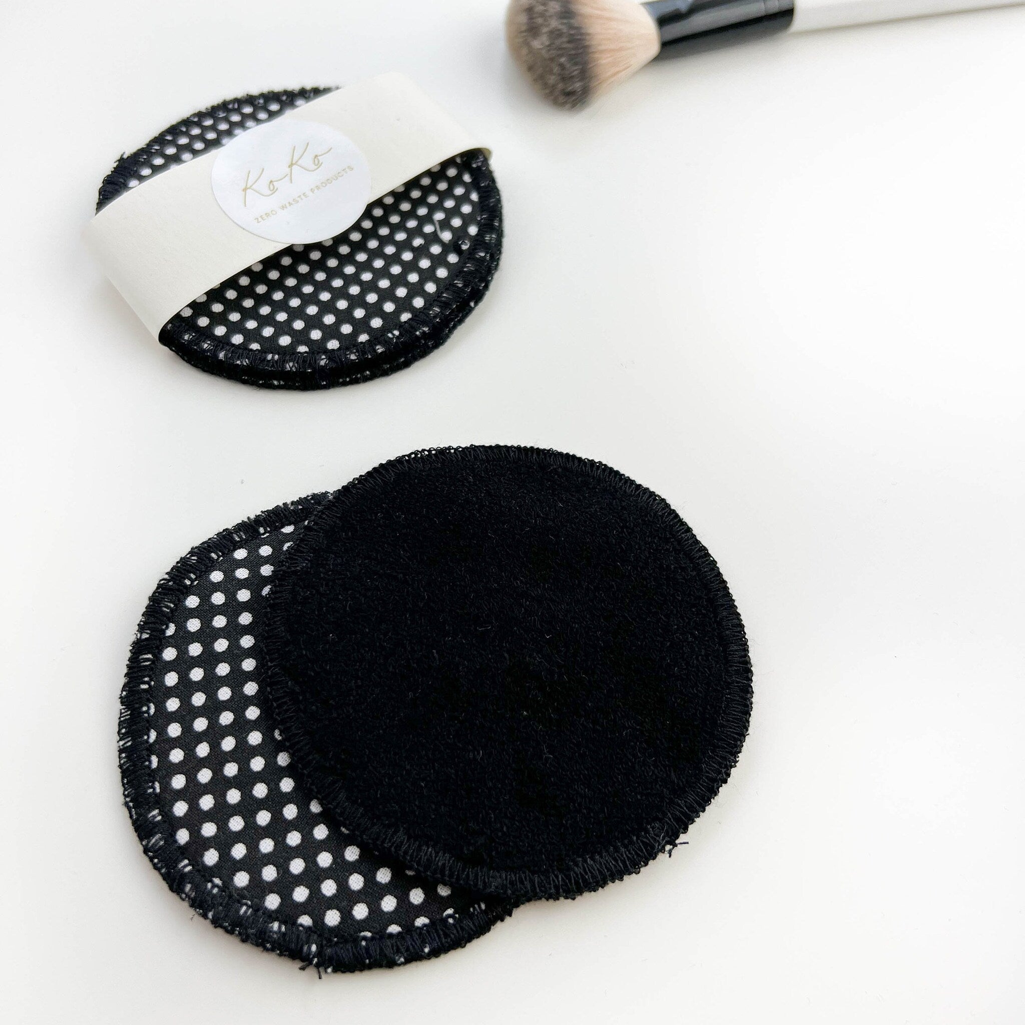 Reusable makeup pads with black and white polka dot pattern and solid black terrycloth, Koko brand visible