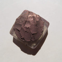 Side view of loose mineral eyeshadow in dark brown with shimmering rose metal finish, vegan and cruelty-free