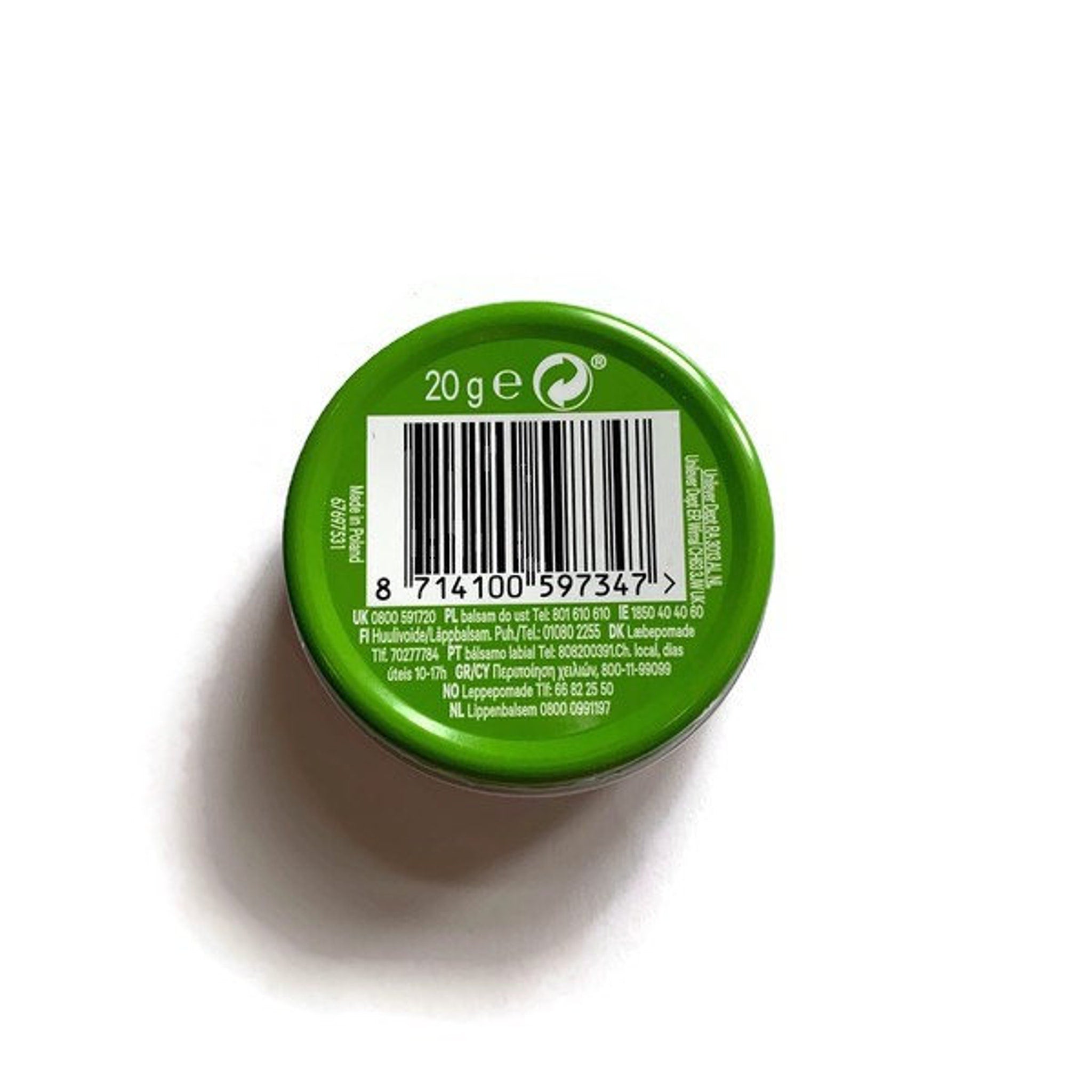 Close-up of mint-green Vaseline lip therapy tin with glossy finish, showcasing aloe vera swirls and gold lettering