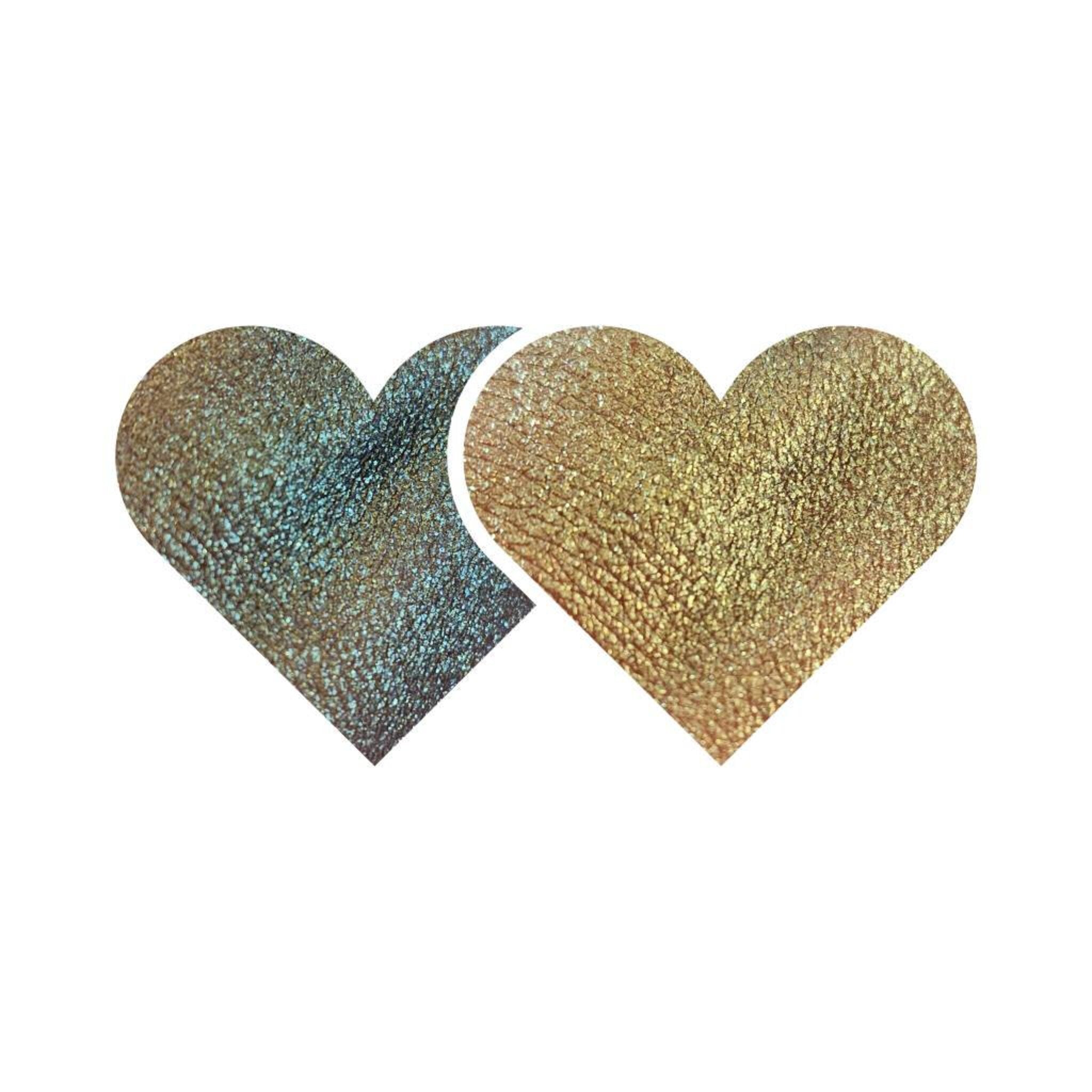 Pressed eyeshadow pan with trichrome chameleon effect shifting between vibrant hues and vegan shimmer glitter.